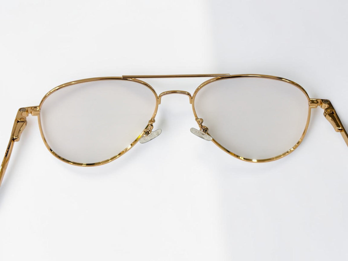 Front view of the gold aviator frame with clear lenses and nose pads