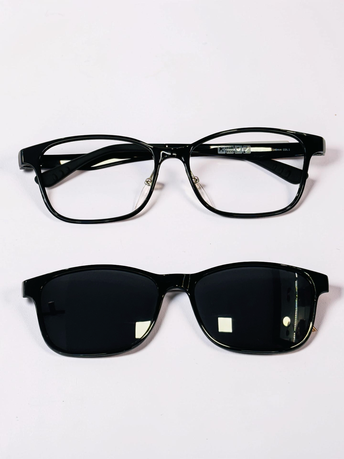 Black rectangular optical frame with dark clip-on shown