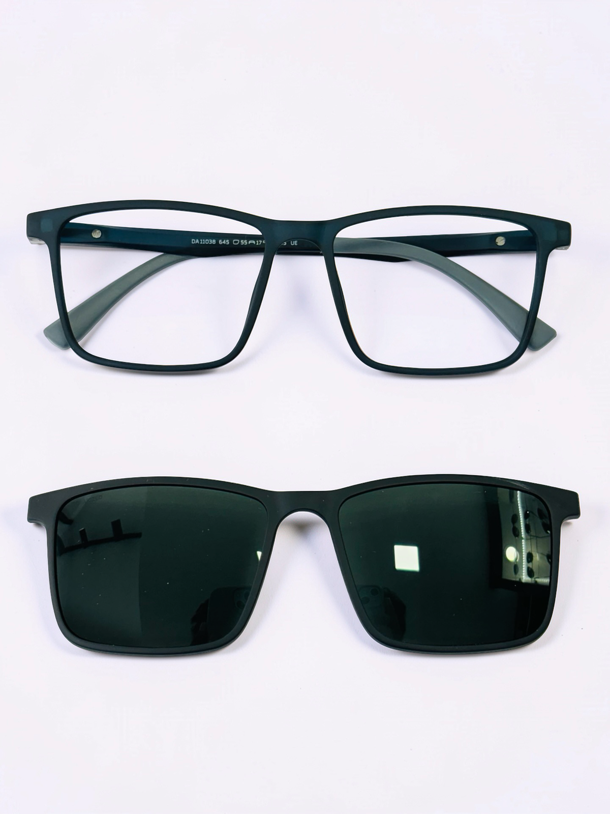 Black square optical frame and detached polarized sunglass clip, front view