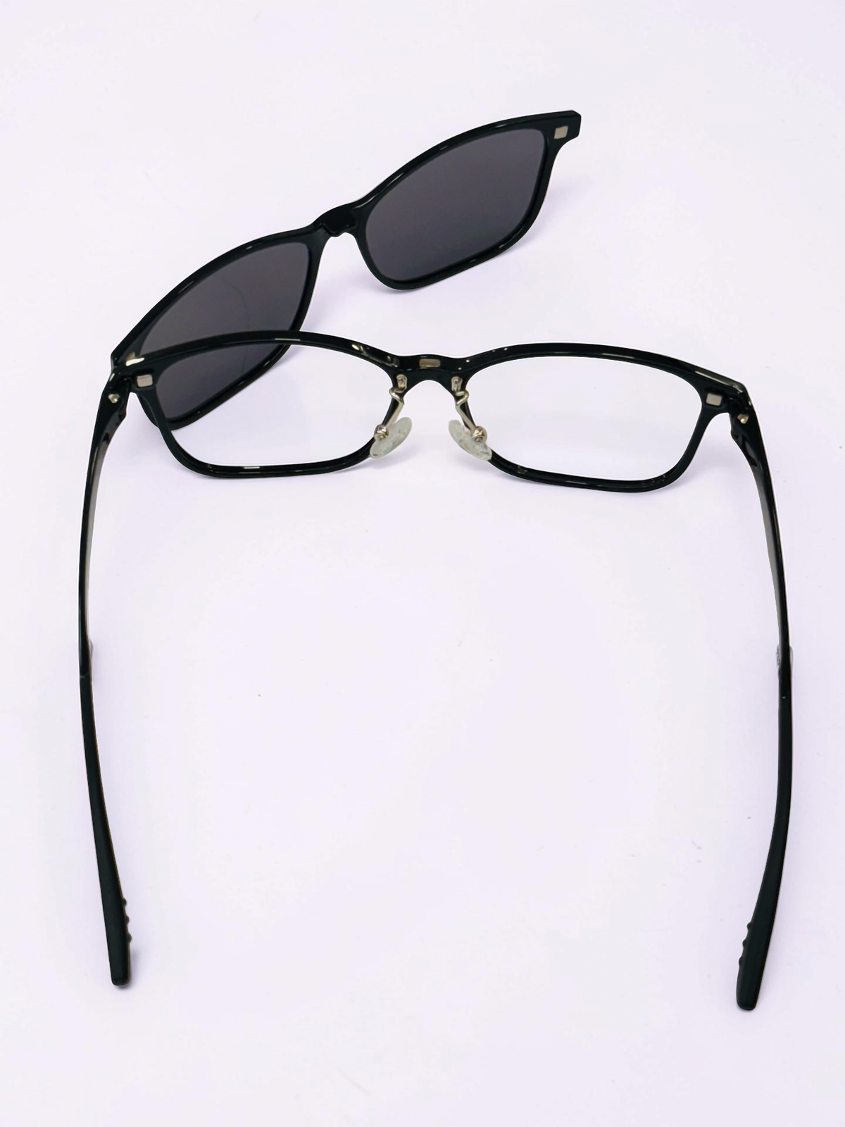 Rear view of black optical frame and dark clip-on