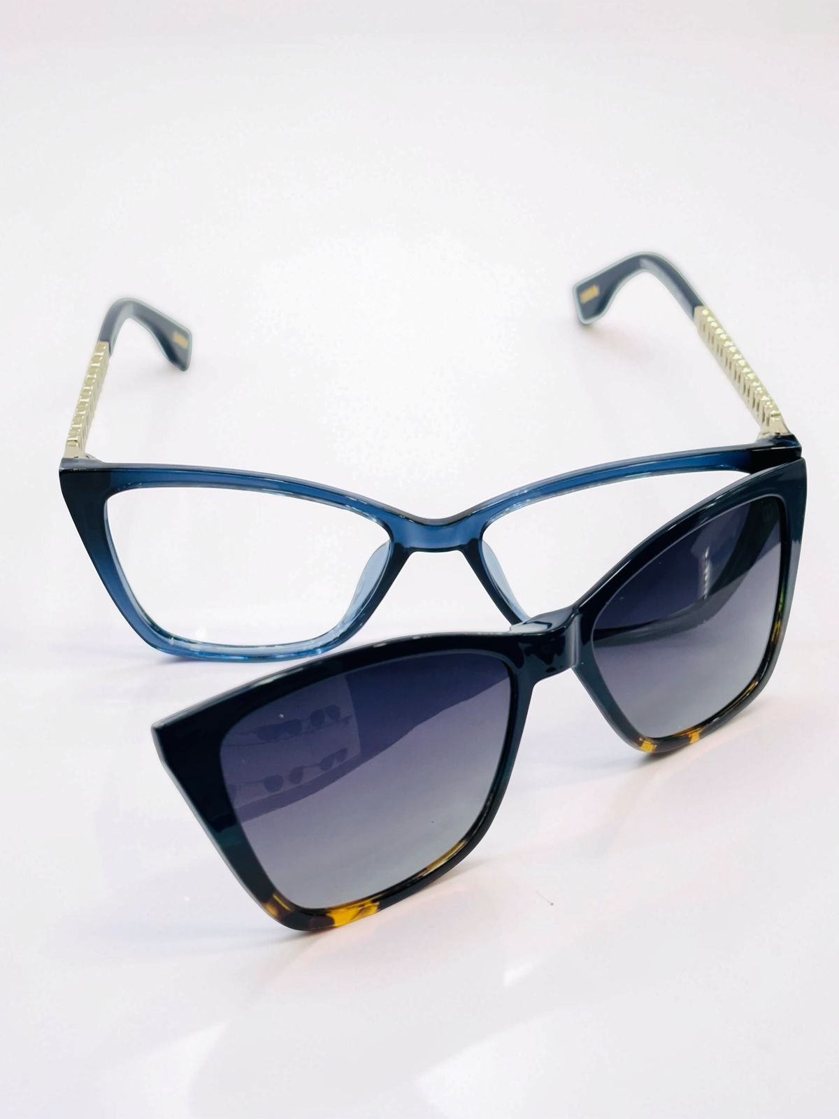 Close-up of deep blue cat-eye frame and decorative gold-tone temple