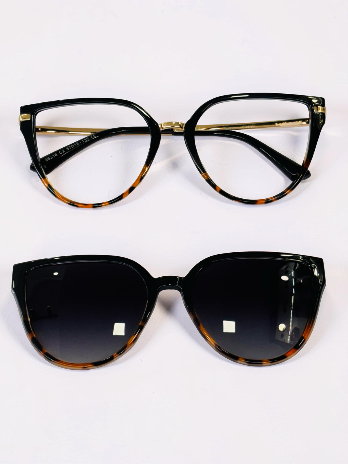 Front view of black and tortoiseshell cat-eye optical frame