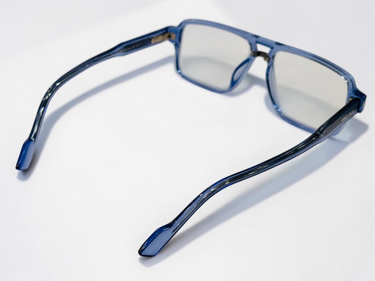Three interchangeable sunglass clips in yellow, dark, and blue gradient shades on the frame