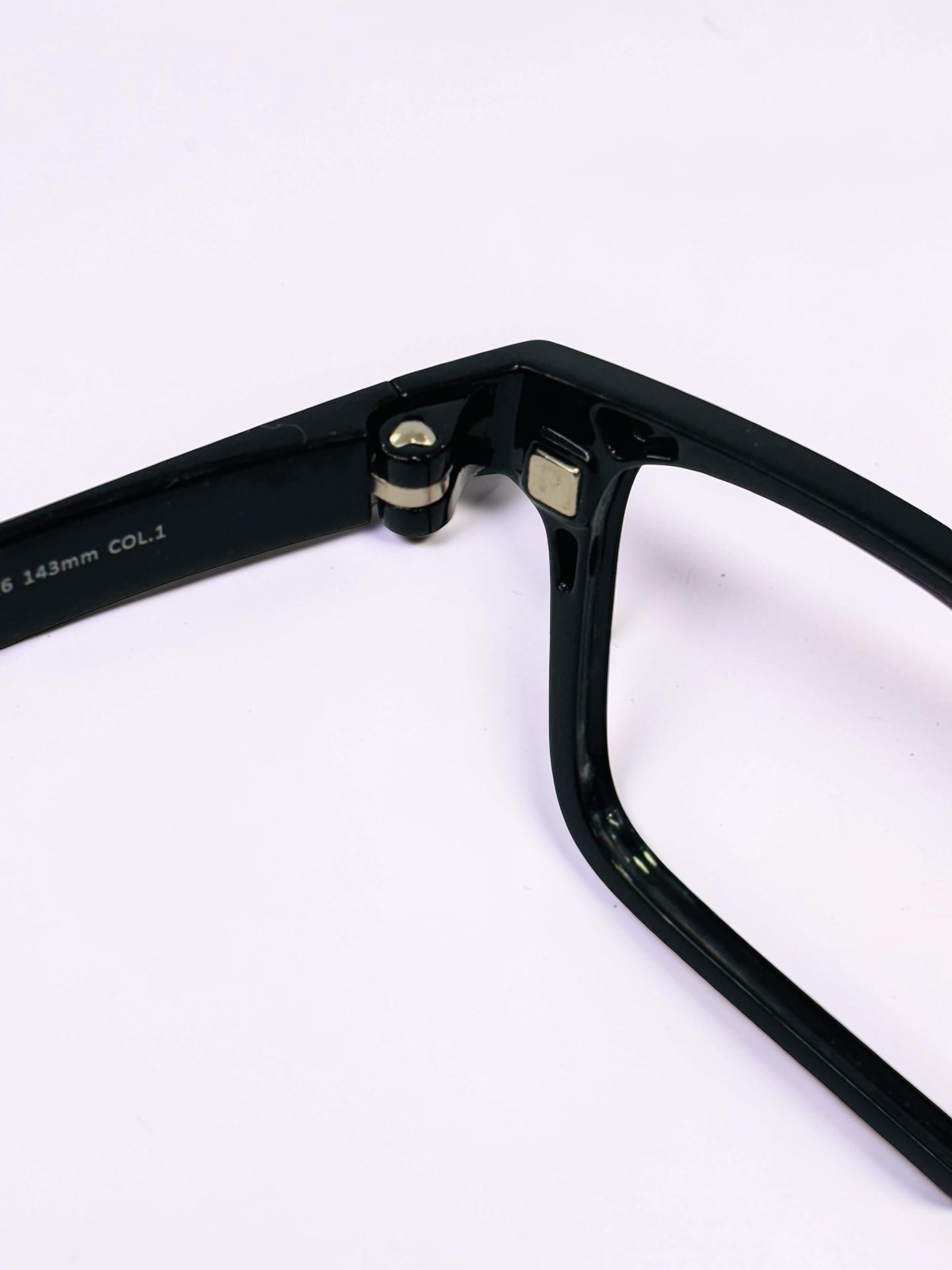 Front view of the black optical frame and tinted clip-on