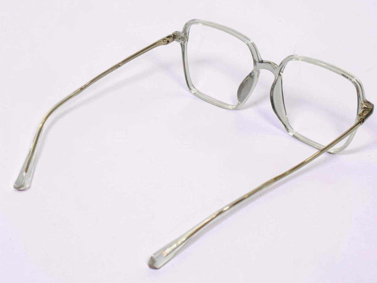 Burgundy sun clip positioned over clear optical frames