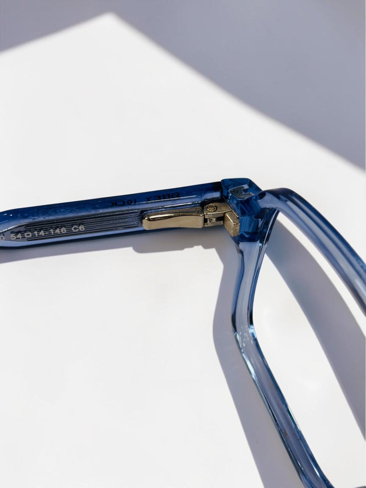 Close-up of the bridge and clear lenses of the blue frame